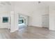 Spacious living room with view of the pool visible through large sliding glass doors, complete with gray flooring at 2168 Calcutta Rd, Punta Gorda, FL 33983