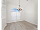 Living room with cathedral ceiling, gray flooring, and a bright window with white curtains at 2168 Calcutta Rd, Punta Gorda, FL 33983