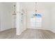 Open concept living room with cathedral ceiling, light gray flooring, and hanging light fixtures at 2168 Calcutta Rd, Punta Gorda, FL 33983