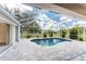 Enclosed pool and patio area for year-round enjoyment, surrounded by beautiful landscaping at 2168 Calcutta Rd, Punta Gorda, FL 33983