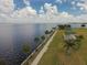Scenic waterfront view with lush green space, paved walking path, and a covered picnic area at 2168 Calcutta Rd, Punta Gorda, FL 33983