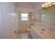Cozy bathroom featuring a shower-tub combo with a bright window and a single sink vanity at 23090 Ambassador Ave, Port Charlotte, FL 33954