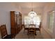 Traditional dining room with elegant wood furniture and a decorative chandelier, creating a warm atmosphere at 23090 Ambassador Ave, Port Charlotte, FL 33954