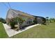 Back exterior view of the house featuring a screened-in patio area at 23090 Ambassador Ave, Port Charlotte, FL 33954