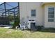 Beige home exterior featuring a pool enclosure, pool equipment and a window at 23090 Ambassador Ave, Port Charlotte, FL 33954
