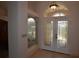 Elegant front entry door with decorative glass panels and transom window, creating a welcoming and bright foyer at 23090 Ambassador Ave, Port Charlotte, FL 33954