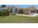 Charming single-story home with well-maintained lawn, landscaping, and neutral color scheme at 23090 Ambassador Ave, Port Charlotte, FL 33954