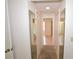Hallway with tiled floor featuring closet with mirrored doors at 23090 Ambassador Ave, Port Charlotte, FL 33954