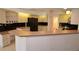 Spacious kitchen featuring modern appliances, ample storage, and a breakfast bar, creating a delightful cooking area at 23090 Ambassador Ave, Port Charlotte, FL 33954