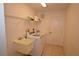 Functional laundry room equipped with a sink, shelving, and a washer and dryer set at 23090 Ambassador Ave, Port Charlotte, FL 33954