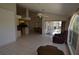 Open floor plan showcases living room, kitchen, and dining area with access to outdoor pool at 23090 Ambassador Ave, Port Charlotte, FL 33954