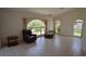 Bright living room with tile floors, large windows, and comfortable seating area at 23090 Ambassador Ave, Port Charlotte, FL 33954