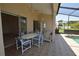 Enclosed patio featuring tile flooring, a large dining table, and views of the pool at 23090 Ambassador Ave, Port Charlotte, FL 33954