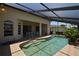 Sparkling pool with a covered patio, tiled deck, and views of the home's exterior at 23090 Ambassador Ave, Port Charlotte, FL 33954