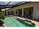 Inviting pool featuring clear water, gradual steps, and a covered patio for relaxation at 23090 Ambassador Ave, Port Charlotte, FL 33954