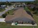 Back exterior view of a home with well-maintained landscaping and a screened-in pool area at 23090 Ambassador Ave, Port Charlotte, FL 33954
