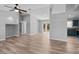 Open-concept living room with wood-look floors, neutral paint, and abundant natural light at 2405 Mistleto Ln, North Port, FL 34286