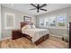 Bright bedroom featuring light wood floors, a window view, and shuttered windows at 2526 Rio Plato Dr, Punta Gorda, FL 33950