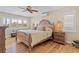 Cozy bedroom with a wooden bed frame, plantation shutters, and wood-style floors at 2526 Rio Plato Dr, Punta Gorda, FL 33950