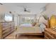 Bright bedroom featuring a decorative wood bed frame, and shuttered windows at 2526 Rio Plato Dr, Punta Gorda, FL 33950