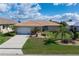 Well-maintained single Gathering home with lush landscaping, covered entryway and two-car garage at 2526 Rio Plato Dr, Punta Gorda, FL 33950