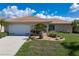 Charming single-story home with a two-car garage and lush landscaping, featuring a beautiful tile roof at 2526 Rio Plato Dr, Punta Gorda, FL 33950