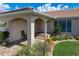 Charming front entrance with decorative columns, stone accents, and landscaped garden at 2526 Rio Plato Dr, Punta Gorda, FL 33950