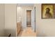 Hallway leading to a bathroom with neutral tones and a decorative art piece on the wall at 2526 Rio Plato Dr, Punta Gorda, FL 33950