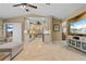 Open-concept living area featuring the kitchen with white cabinets, tile floors, and seamless access to a dining area at 2526 Rio Plato Dr, Punta Gorda, FL 33950