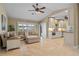 Open-concept living room with sleek tile flooring and well-lit kitchen view at 2526 Rio Plato Dr, Punta Gorda, FL 33950
