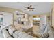 Open-concept living space with comfortable seating, a ceiling fan, and bright views at 2526 Rio Plato Dr, Punta Gorda, FL 33950