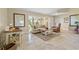 Bright living room features neutral tones, tile flooring, and comfortable seating arrangement at 2526 Rio Plato Dr, Punta Gorda, FL 33950