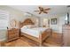 Bright main bedroom featuring a decorative wood bed frame, and shuttered windows at 2526 Rio Plato Dr, Punta Gorda, FL 33950