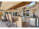 Outdoor bar area with bar seating, stainless steel beverage fridge, and TV at 2526 Rio Plato Dr, Punta Gorda, FL 33950