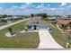 View of the neighborhood showcasing the home's well maintained lawn, landscaping and comfortable neighborhood at 25308 Rupert Rd, Punta Gorda, FL 33983