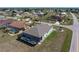 Aerial shot of the home with a screened lanai and pool, plus a view of the landscaping at 25308 Rupert Rd, Punta Gorda, FL 33983