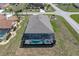Aerial view showcasing the screened-in pool, lanai, and the home's location within the neighborhood at 25308 Rupert Rd, Punta Gorda, FL 33983