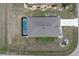 Birds-eye view of the home displaying the roof, driveway, landscaping, and screened-in pool area at 25308 Rupert Rd, Punta Gorda, FL 33983