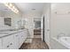 Bathroom showing double vanity, soaking tub and shower with neutral color palette at 25308 Rupert Rd, Punta Gorda, FL 33983