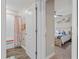 Bathroom with a tub-shower combo with wood-look tile floors and modern fixtures at 25308 Rupert Rd, Punta Gorda, FL 33983