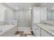 Bathroom featuring a soaking tub, glass shower, and dual sinks with granite countertops at 25308 Rupert Rd, Punta Gorda, FL 33983