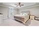 Spacious bedroom with tray ceiling, plush carpeting, and ample natural light at 25308 Rupert Rd, Punta Gorda, FL 33983