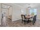 Cozy dining room with a chandelier, wood table with seating for six, tile floors and bright light at 25308 Rupert Rd, Punta Gorda, FL 33983
