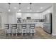 Contemporary kitchen features white cabinets, stainless steel appliances, granite counters and a breakfast bar at 25308 Rupert Rd, Punta Gorda, FL 33983