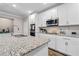 Bright kitchen features granite countertops, stainless appliances and white cabinets at 25308 Rupert Rd, Punta Gorda, FL 33983