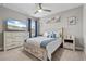 This main bedroom offers a ceiling fan, a large TV, and stylish decor at 25308 Rupert Rd, Punta Gorda, FL 33983