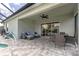 Relaxing covered patio with comfortable outdoor seating, ceiling fan, and a view of the screened-in pool at 25308 Rupert Rd, Punta Gorda, FL 33983