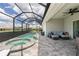 Inviting screened-in lanai with a pool, hot tub, and comfortable seating area, perfect for outdoor relaxation at 25308 Rupert Rd, Punta Gorda, FL 33983