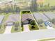 Aerial view of the property showing landscaping, roof, driveway, and surrounding neighborhood at 25312 E Lenox Cir, Punta Gorda, FL 33950