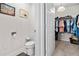 Half bathroom featuring an open walk-in closet with hanging clothes for easy storage at 25312 E Lenox Cir, Punta Gorda, FL 33950